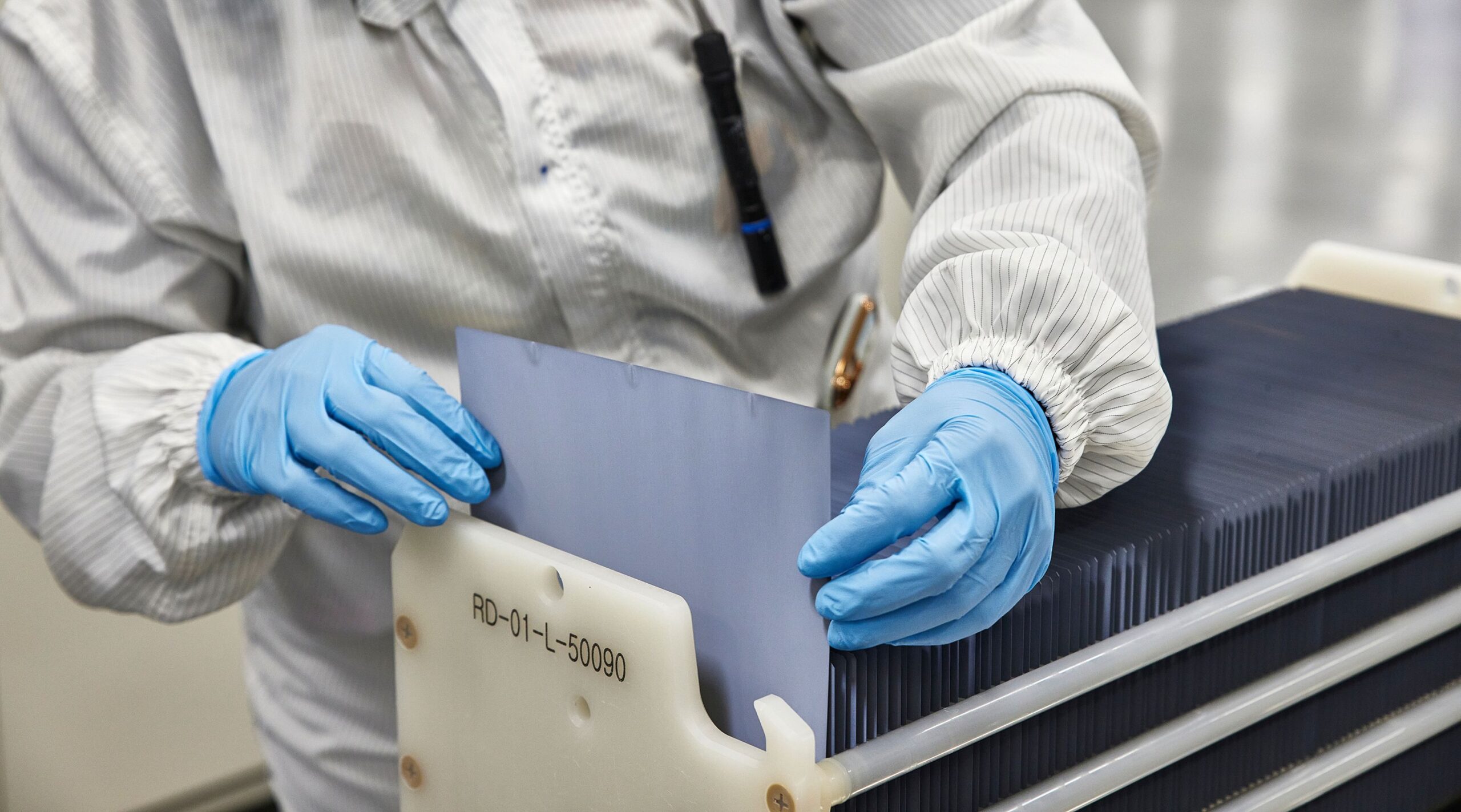 <i>Matt Odom/Bloomberg/Getty Images via CNN Newsource</i><br/>An employee inspects a silicon wafer at the Hanwha QCells solar panel manufacturing plant.