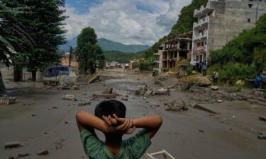 A boy looks at the devastation caused by flash flooding along the Trishuli River in Nepal's Nuwakot district on Wednesday.