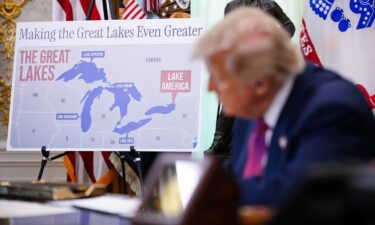 A map displaying Lake Ontario as "Lake America" is seen as President Donald Trump signs an executive order in the Oval Office of the White House on August 27