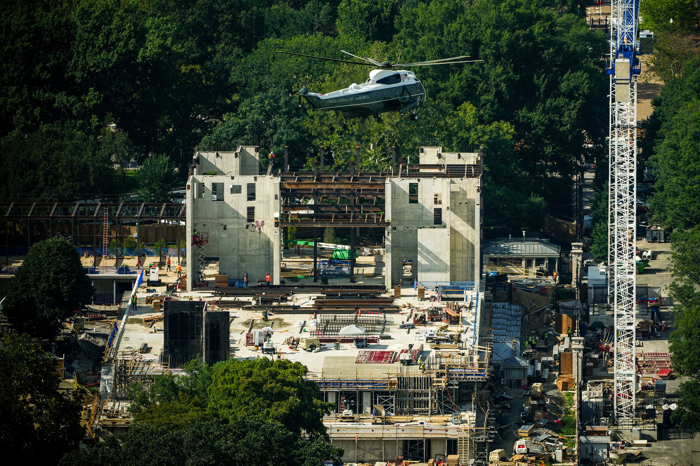 Marine One carries President Donald Trump as it passes over construction on the new White House ballroom, seen from the Washington Monument in Washington, DC, on August 21.