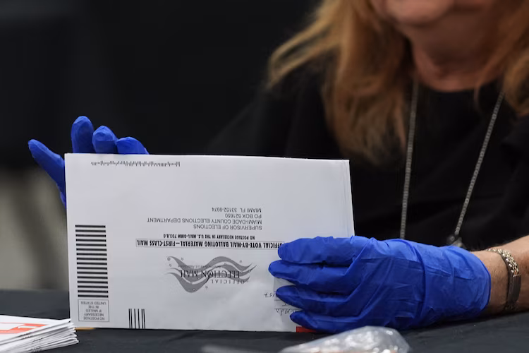 An election worker sorts vote-by-mail ballots at the Miami-Dade County Supervisor of Elections Office for the Florida primary election in Doral, Fla., Tuesday, Aug. 18, 2026.
