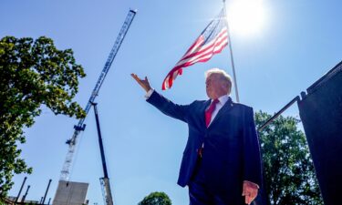 President Donald Trump speaks to members of the media near the White House helipad construction