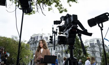 CNN Correspondent Julia Benbrook prepares for a television report on a street corner outside the White House grounds after earlier being denied entry