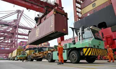 Cranes load containers onto a ship at the Port of Ningbo-Zhoushan in Ningbo
