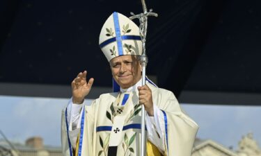 Pope Leo XIV on stage next to French bishop Etienne Guillet during a prayer vigil with young people at the Stade de France.