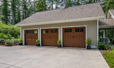 What is the difference between R-value and U-factor in garage doors?