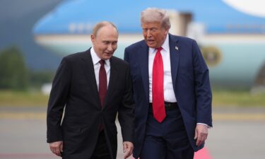 President Donald Trump walks with Russian President Vladimir Putin as they arrive at Joint Base Elmendorf-Richardson on August 15