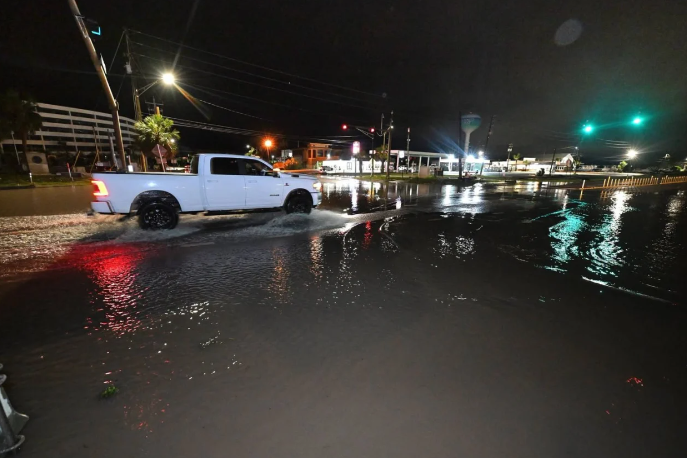 <i>Okaloosa Board of County Commissioners via CNN Newsource</i><br/>A motorist drives along a flooded road in Okaloosa County