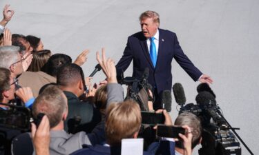 President Donald Trump speaks to press members before boarding Marine One on the South Lawn of the White House in Washington DC