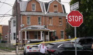 A law enforcement officer carries evidence bags
