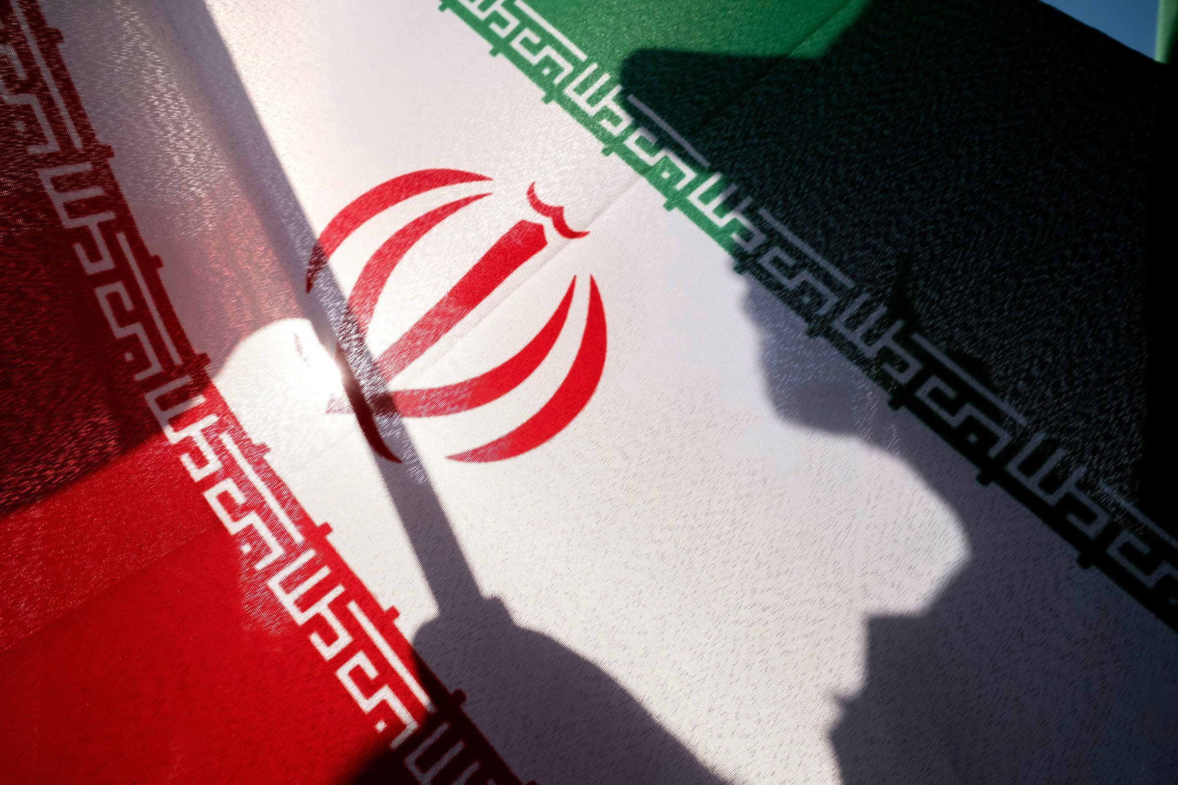 <i>Morteza Nikoubazl/NurPhoto/AP/File via CNN Newsource</i><br/>An Islamic Revolutionary Guard Corps personnel holds an Iranian national flag while preparing to take part in a military parade in southern Tehran