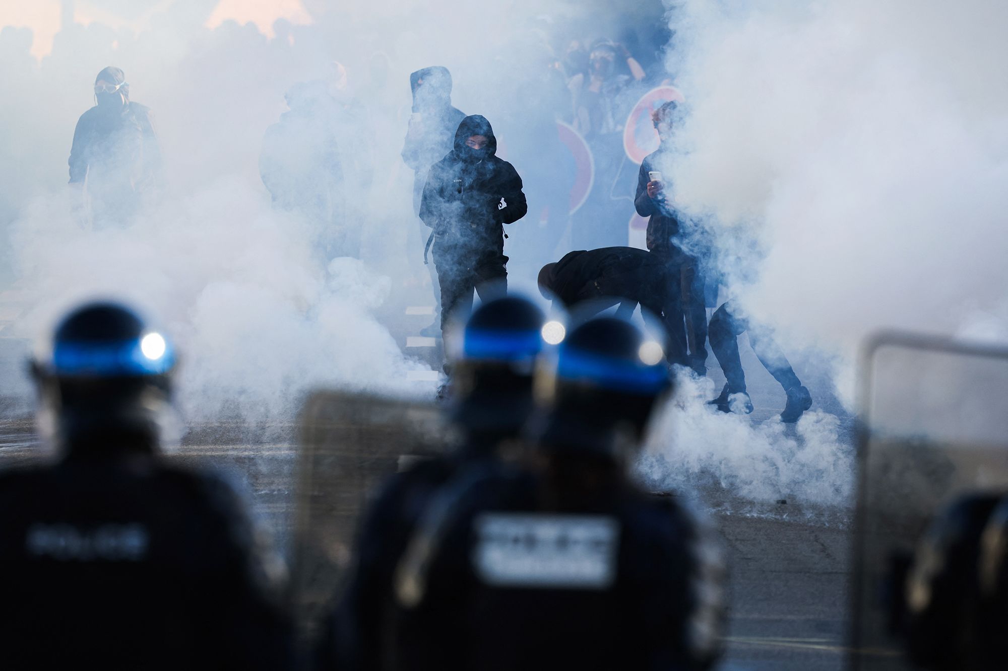 <i>Thomas Samson/AFP/Getty Images via CNN Newsource</i><br/>Firefighters extinguish a fire at the entrance of the Leonard de Vinci secondary school in Paris following a protest on Friday.