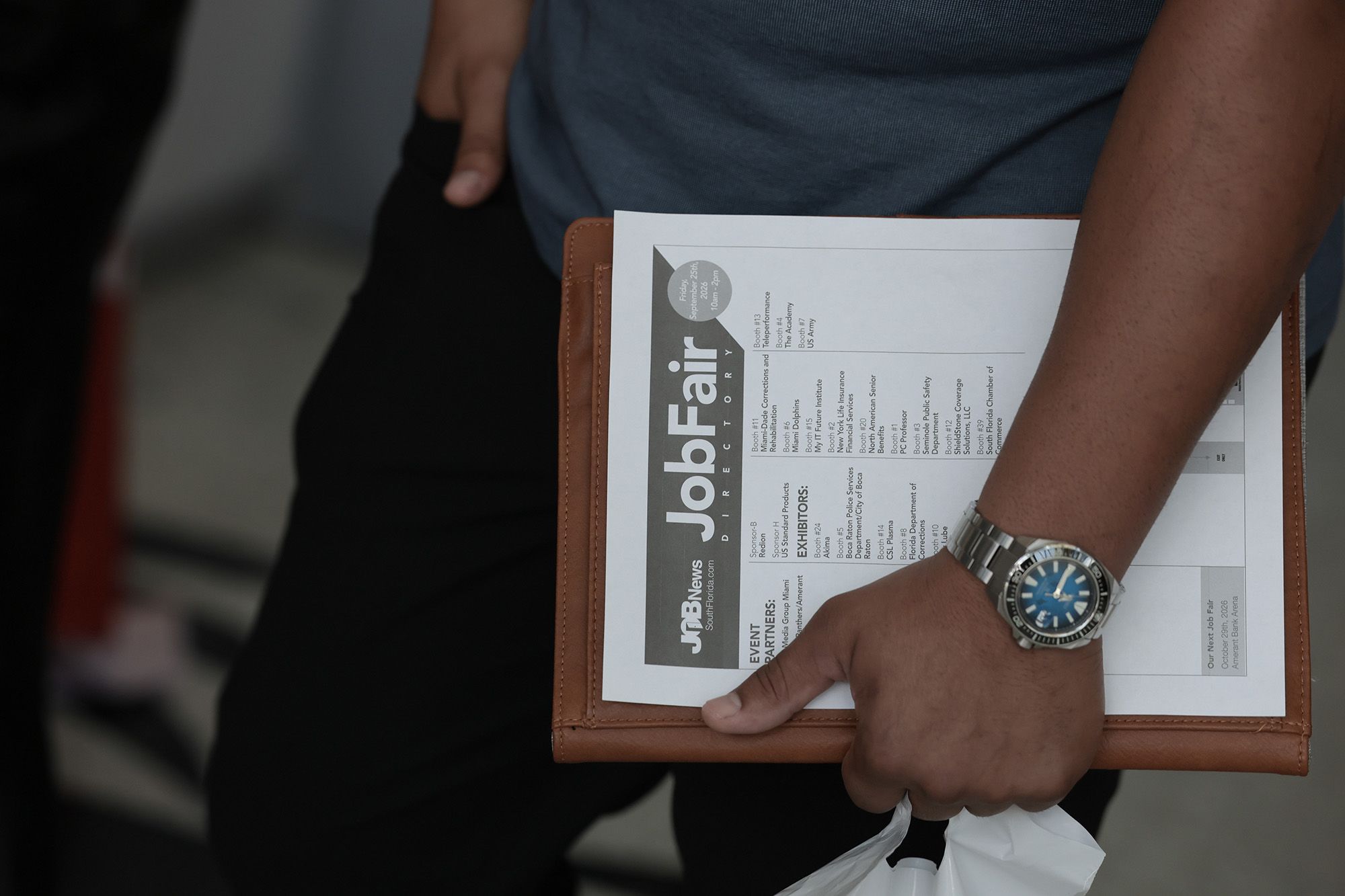 <i>Joe Raedle/Getty Images via CNN Newsource</i><br/>A job seeker holds paperwork during the Mega JobNewsUSA South Florida Job Fair on September 25