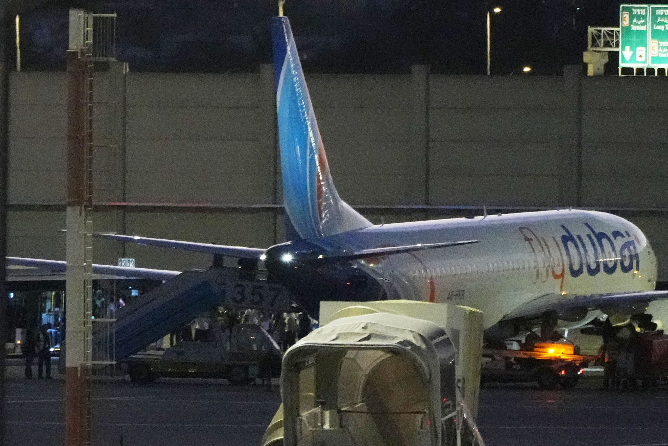 <i>Ariel Schalit/AP via CNN Newsource</i><br/>People disembark from a FlyDubai flight carrying Israeli passengers who had earlier been aboard another FlyDubai aircraft that made an emergency landing in Saudi Arabia on September 30.