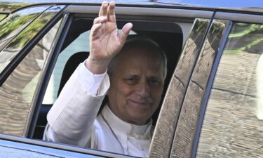Pope Leo XIV waves from the window of the car as he leaves the Vatican before being admitted to Rome's Gemelli University Hospital for an operation to remove a lump from his lung