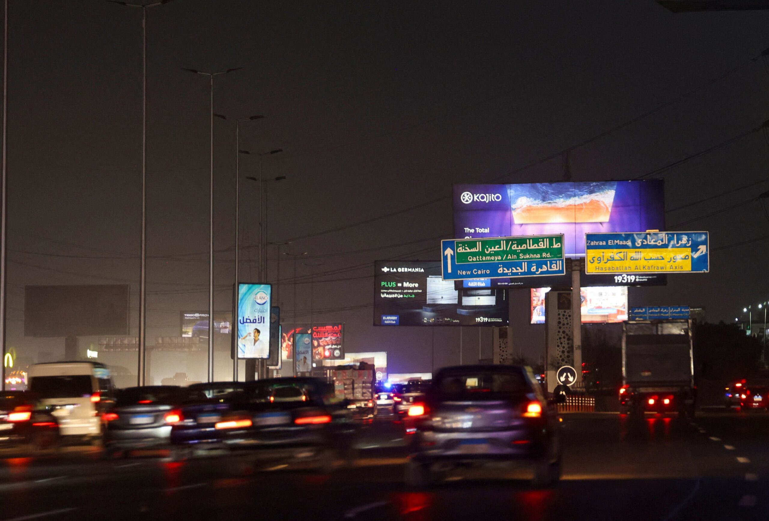 <i>Amr Abdallah Dalsh/Reuters/File via CNN Newsource</i><br/>Vehicles drive past brightly lit billboards in Cairo