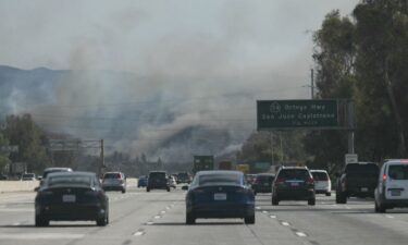 Cars drive along Interstate 5 toward the Norte Fire in San Juan Capistrano