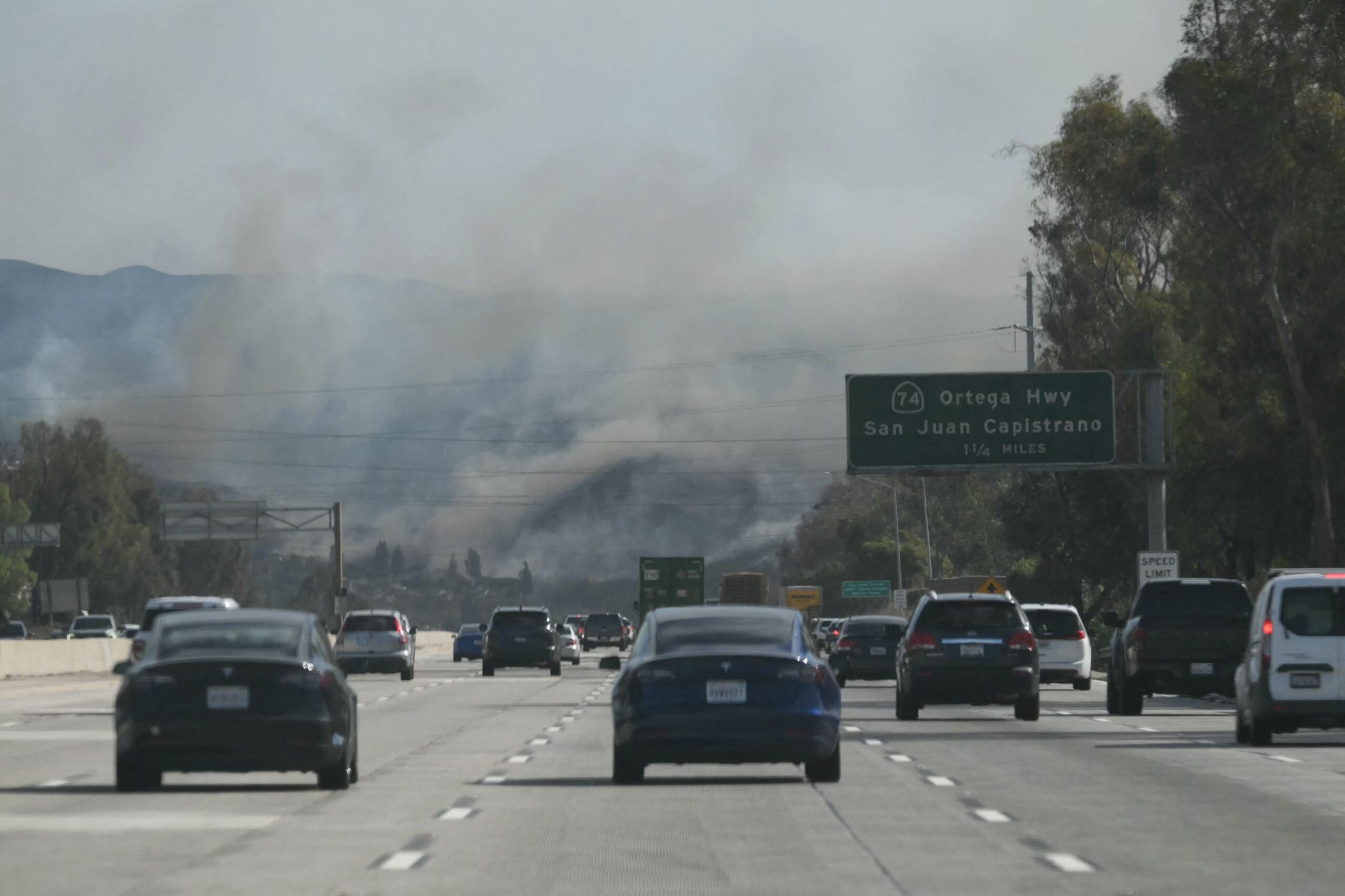 <i>Patrick T. Fallon/AFP/Getty Images via CNN Newsource</i><br/>Cars drive along Interstate 5 toward the Norte Fire in San Juan Capistrano