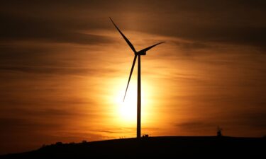 A wind turbine generates electricity at sunset in Balabanli