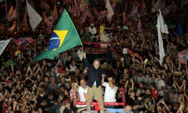 A street vendor arranges campaign flags for sale featuring Brazilian President Luiz Inacio Lula da Silva