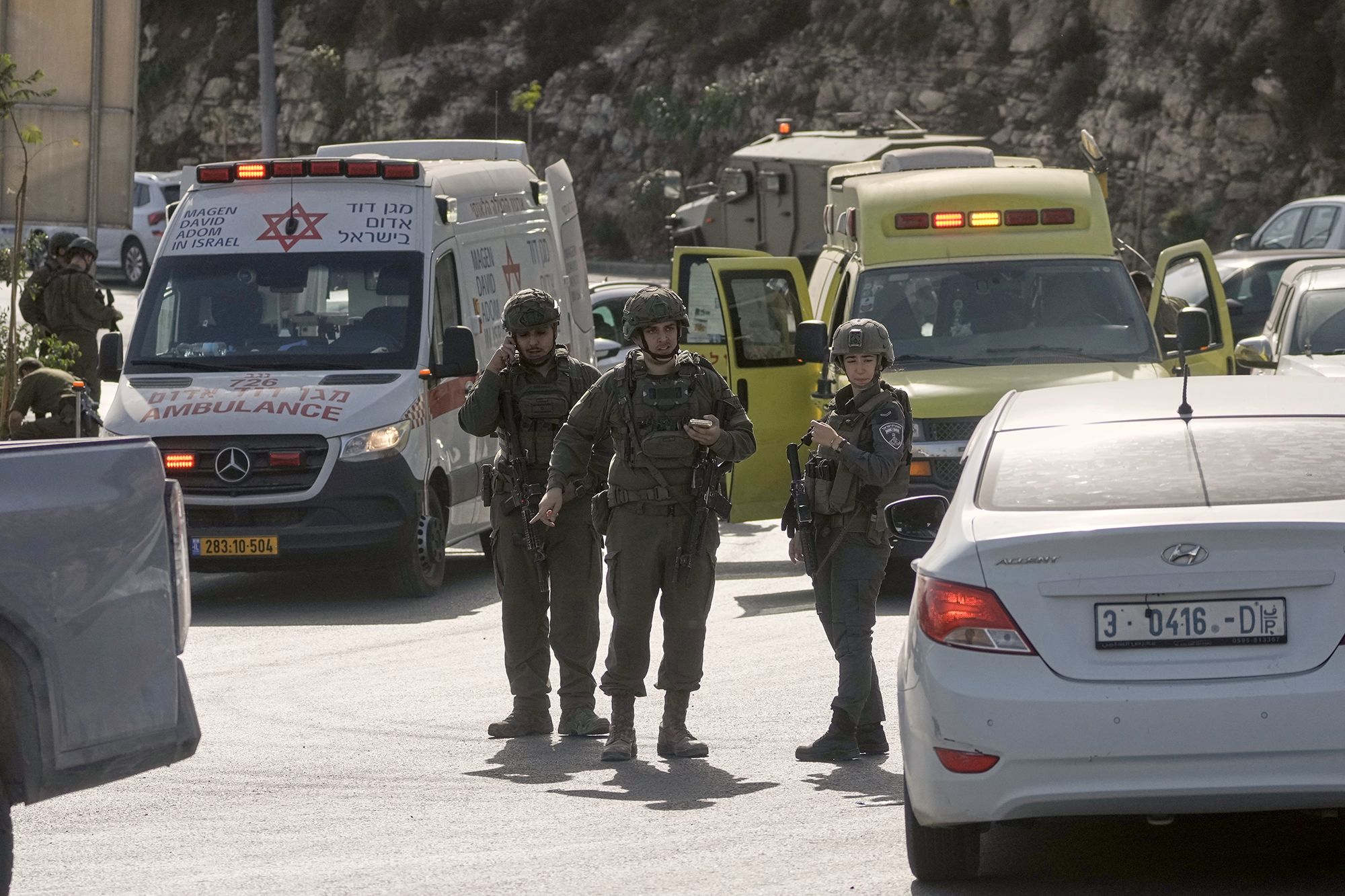 <i>Mahmoud Illean/AP via CNN Newsource</i><br/>Israeli soldiers and emergency personnel gather near the scene of a shooting attack at a junction near Hebron in the occupied West Bank