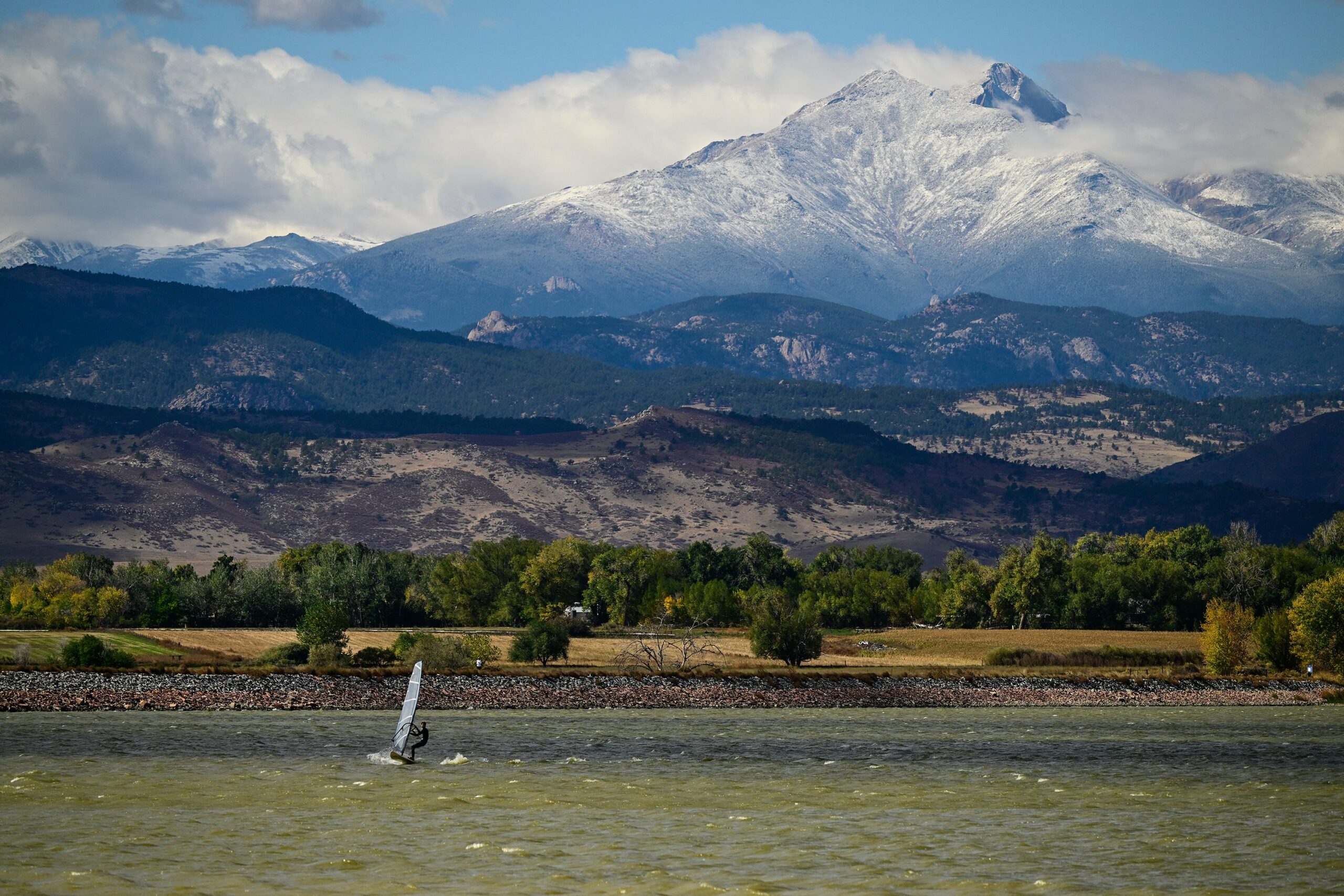 <i>Matthew Jonas/MediaNews Group/Boulder Daily Camera/Getty Images via CNN Newsource</i><br/>A windsurfer cuts across McIntosh Lake in front of the snow covered peaks of Mount Meeker and Longs Peak in Longmont