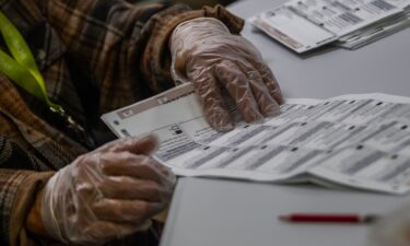 An election worker handles ballots at the Orange County Registrar of Voters Facility on October 28
