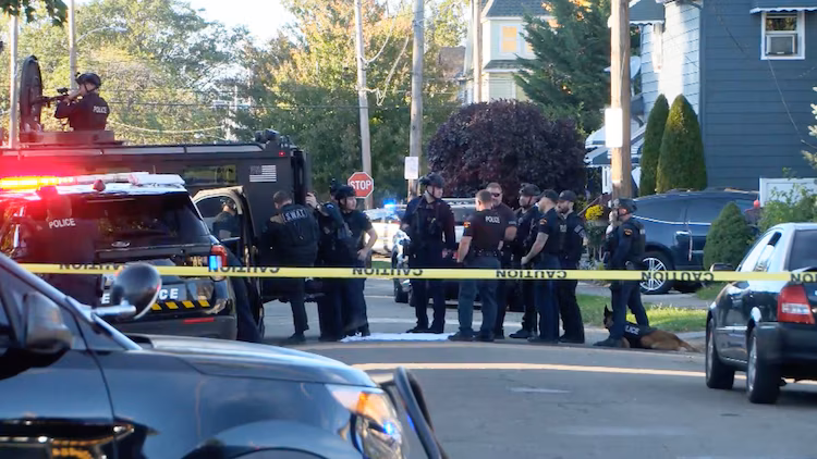 In this screen grab from a video, a SWAT team and other law enforcement officials are shown at the scene of a shooting in Erie, Pa., on Oct. 9, 2026.
