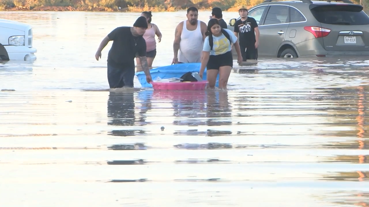 Horizon residents float their belongings on floodwater after runoff impacted a neighborhood off Horizon Boulevard. 