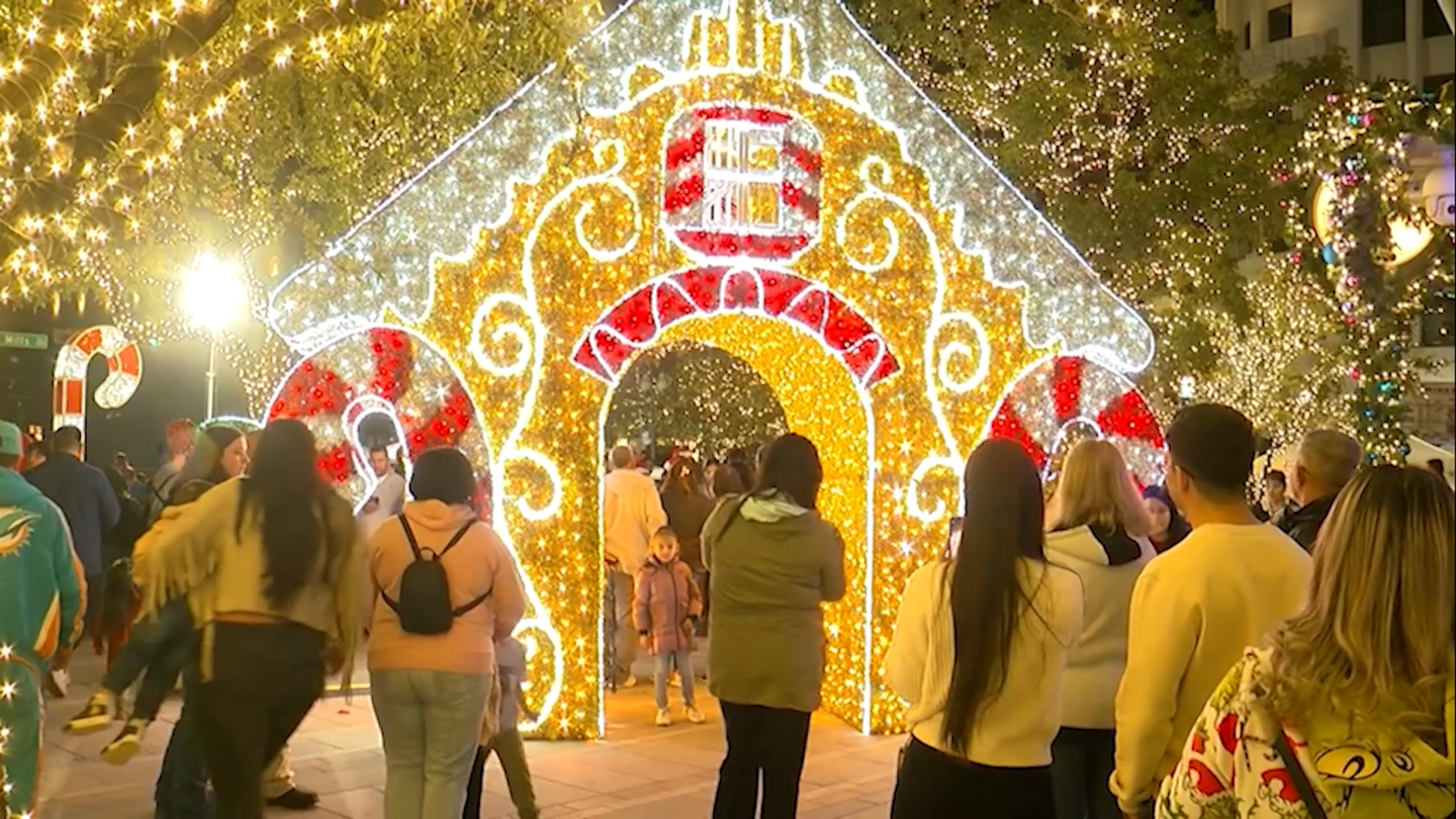 Families pose for pictures underneath one of WinterFest's displays.